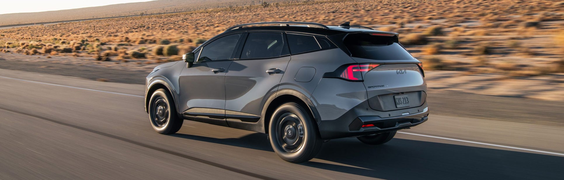 Kia SUV driving on the desert freeway