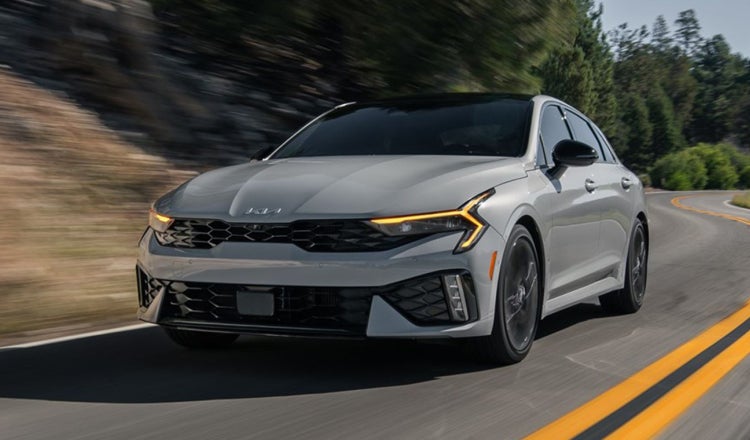 Kia Sedan driving on the highway